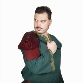 Looking for the best accessory that could make your ordinary costume a truly outstanding one? This leather pauldron, richly embossed with Mercia Kingdom design, will surely befit this character. This pauldron is provided as a single shoulder costume piece. Handcrafted from robust genuine buff leather, these offer great durability and longevity. The pure brass rivets hold the two leather plates, supporting a robust construction to last, event after event. This pauldron is ideal for LARP, cosplay or any barbarian character from your favourite fantasy realm.