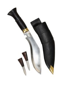 The Nepal Police Service Kukri crafted by differs from its military counterpart by having a broader blade, a rosewood handle and the crossed Kukri emblem on the pommel. Crafted by Ex-Gurkha Khukuri House has a blade of 5160 high carbon steel. The blade has been differentially tempered to make the edge steel harder than the body – this creates a blade that does not dull easily at the edge, yet is soft enough so that it can flex to absorb shock and prevent breakage due to being too hard and brittle.
The hilt fittings are of brass and the grip is of carved rosewood. The companion scabbard is made in the traditional fashion with two carved halves of pinewood and Laha tree gum glue. It is finished with an outer layer of black leather, a brass tip and a belt loop. It comes with a pair of traditional tools and a space for them in the scabbard. These are a Karda utility knife and a sharpening tool, the thicker Chakmak. The two knives match the larger Khukuri by having blades of high carbon steel and carved rosewood grips.