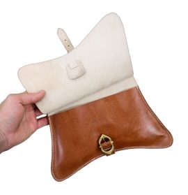This handcrafted medieval belt pouch is crafted from quality leather and is dyed to a natural tan hue and embossed with crosses. The pouch has finely stitched construction and it is secured with an adjustable brass buckle and leather strap. The pouch is completed with an integrated belt loop by which this pouch can either be fitted to a thin belt – or a cord could be laced through these loops for hanging to a larger belt.