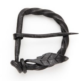 This hand forged iron buckle is attractive and rugged, just like the swashbuckling hero himself. Understated, but with an air of charm. Fits up to a 2" belt.     Approx. 3-1/8" x 2-1/2"  