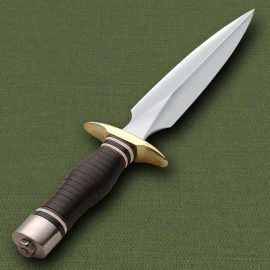The experts at Windlass Steelcrafts have meticulously recreated this 1947 fighting knife from an original of the era that had been made by a famous maker of the day. Double edge, high carbon steel blade with full tang. The wood grip is heavily contoured with multiple color leather wrap. Solid steel pommel and polished brass finger guard.  A real beauty for the collector and still very effective in the right hands. Includes heavy grade, leather belt sheath with sharpening stone.  Key Measurements:    Overall: 13-1/2"  Blade: 7"       Cannot be shipped to CA or MA 